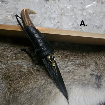 Decorative knife with black handle and gold accents on a fur surface